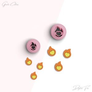 May include: A set of pink and orange cookie cutters shaped like flames with hearts inside. The cutters are arranged on a white surface. "Digital File" is written in the bottom right corner of the image.