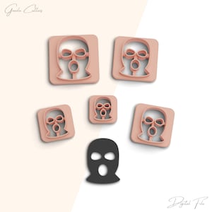 May include: Five pink plastic cookie cutters shaped like a ski mask, and one black ski mask cookie cutter. The cookie cutters are arranged in a circle around the black cookie cutter.