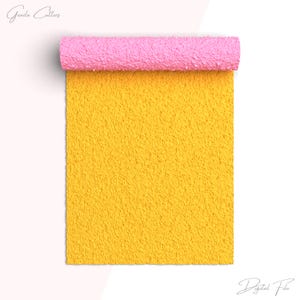 May include: A yellow fuzzy fabric with a pink fuzzy edge rolled up. The fabric is textured and has a soft, plush appearance.