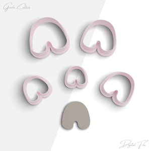 May include: Set of six pink plastic cookie cutters shaped like different variations of a heart. The cutters are arranged on a white background.  The text "Digital File" is visible in the bottom right corner of the image.
