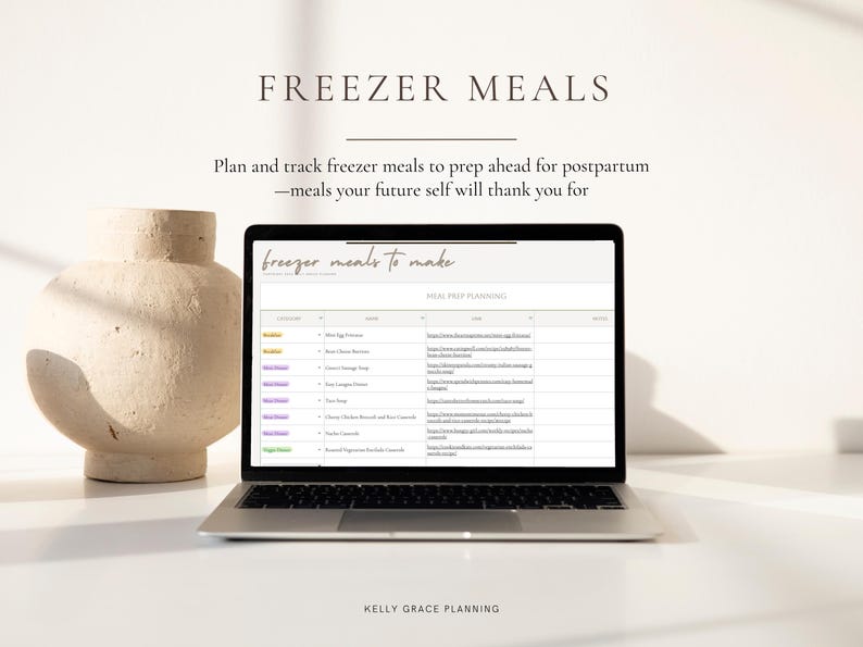 May include: A laptop displaying a meal prep planning document with the text "Freezer Meals" and "freezer meals to make". A beige vase is to the left of the laptop. The text "Kelly Grace Planning" is at the bottom.