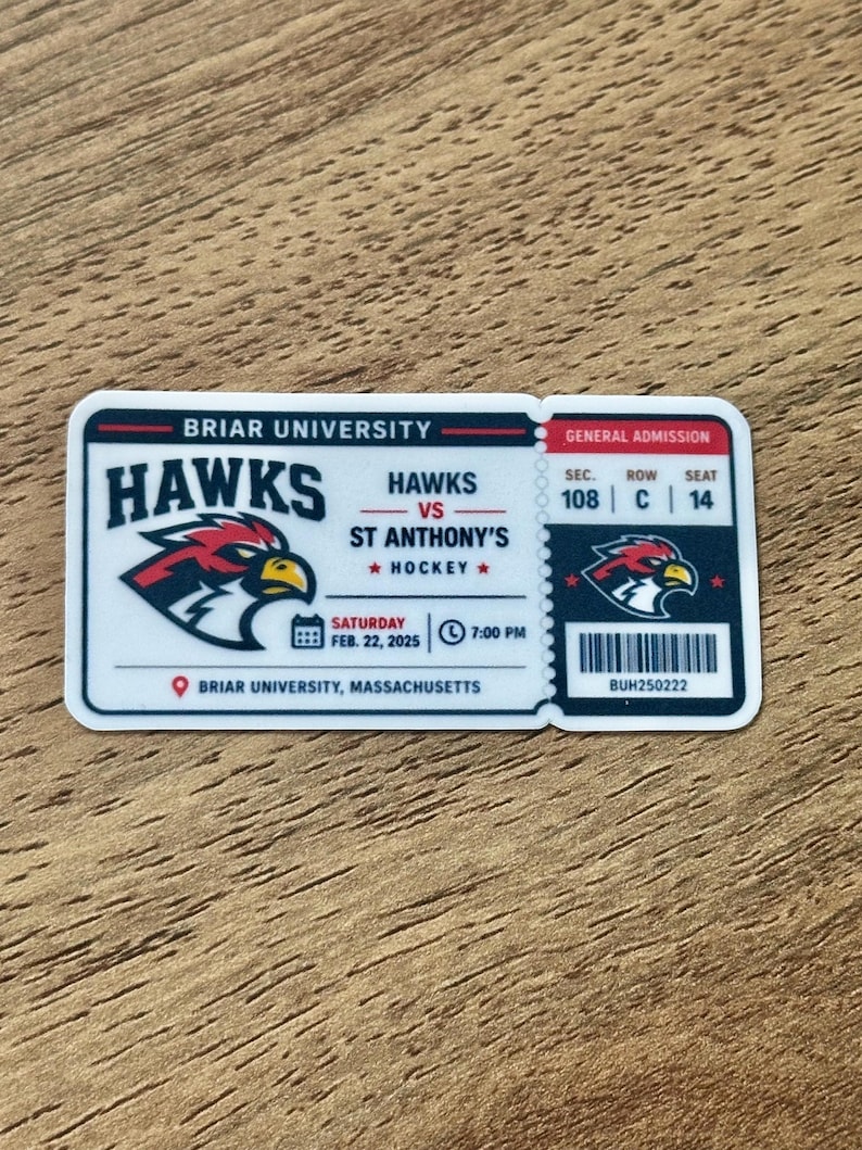 May include: A rectangular sticker designed as a Briar University Hawks vs. St. Anthony's hockey ticket. It features a hawk mascot logo, the date Saturday Feb. 22, 2025, at 7:00 PM, location in Massachusetts, and seat details: Sec. 108, Row C, Seat 14.