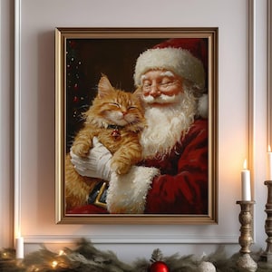 May include: A framed painting of Santa Claus holding a ginger cat in his arms. The painting is set against a white fireplace mantel with a garland of greenery and Christmas lights. There are two candlesticks with white candles on the mantel.