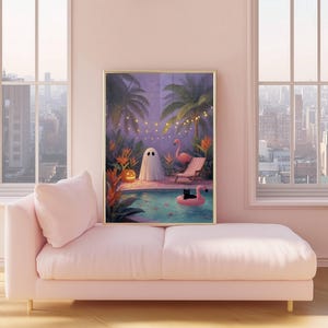 May include: A framed art print depicts a whimsical Halloween scene. A ghost stands by a pool with a black cat on a flamingo float. Palm trees, string lights, and a jack-o'-lantern add to the spooky, yet serene, atmosphere. The artwork is displayed on a pink chaise lounge.