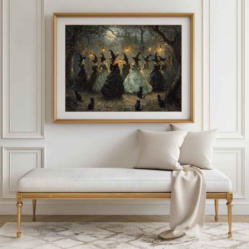 May include: A framed print depicts a gathering of witches in a moonlit forest. The witches, in elegant gowns and pointed hats, are surrounded by black cats. The artwork is set in a gold frame, adding a touch of sophistication to the mystical scene.