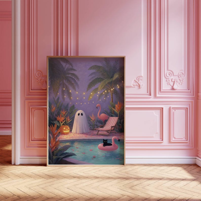 May include: A framed art print depicts a whimsical scene of a ghost, a flamingo, and a black cat in a pool. Palm trees, string lights, and a jack-o'-lantern add to the tropical Halloween theme. The artwork is set against a pink wall.