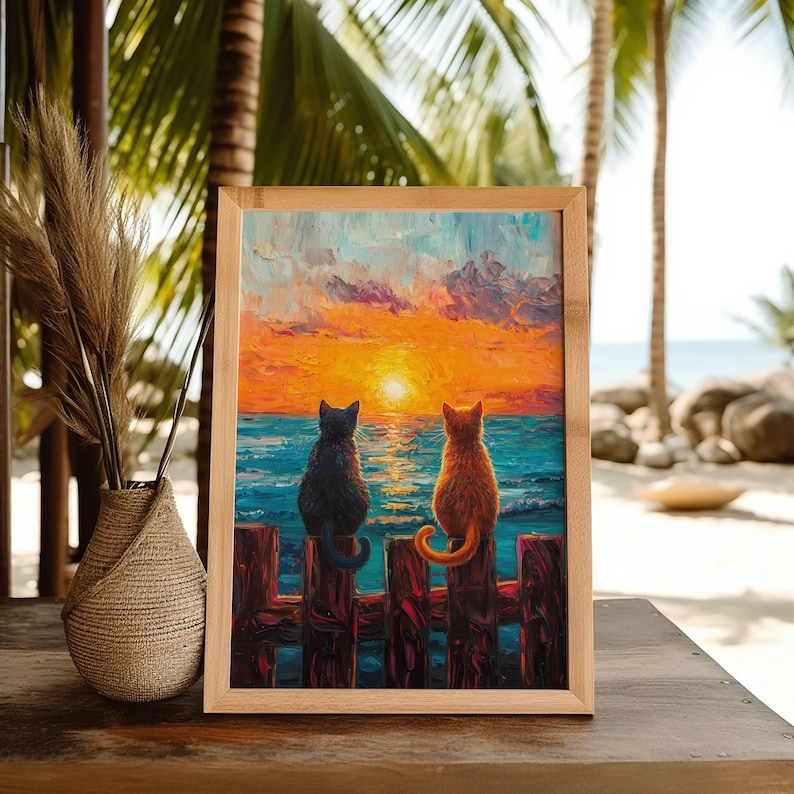 May include: A framed painting of two cats sitting on a wooden fence overlooking a sunset over the ocean. The cat on the left is black and the cat on the right is orange.