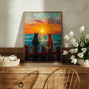 May include: A painting of two cats sitting on a wooden fence overlooking a sunset over the ocean. The cat on the left is black and the cat on the right is orange.