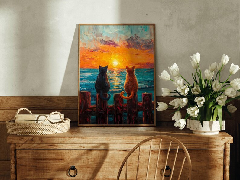 May include: A painting of two cats sitting on a wooden fence overlooking a sunset over the ocean. The cat on the left is black and the cat on the right is orange.