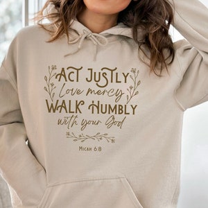 May include: Beige hoodie with a brown graphic print that reads "Act justly, love mercy, walk humbly with your God, Micah 6:8".