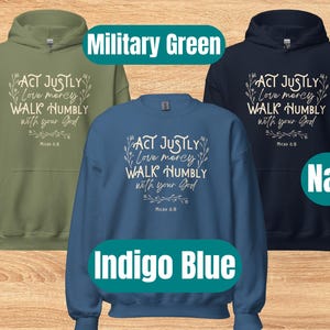 May include: Three hooded sweatshirts in different colors: military green, indigo blue, and navy. Each sweatshirt features a white graphic with the text "ACT JUSTLY Love mercy WALK HUMBLY with your God Micah 6:8".