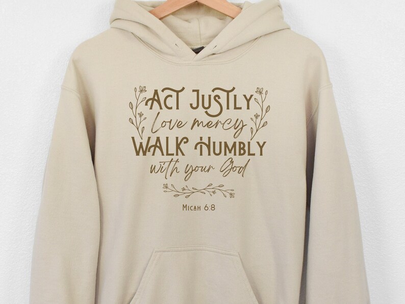 May include: Beige hoodie with a brown graphic print that reads "Act justly, love mercy, walk humbly with your God, Micah 6:8".