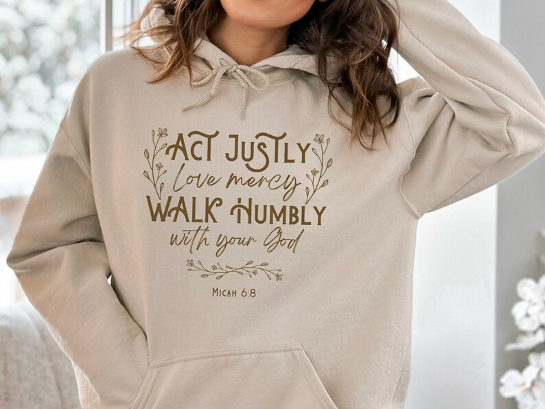 May include: Beige hoodie with a brown graphic print that reads "Act justly, love mercy, walk humbly with your God, Micah 6:8".