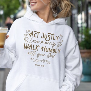 May include: White hoodie with a brown graphic print that says "Act justly, love mercy, walk humbly with your God, Micah 6:8".