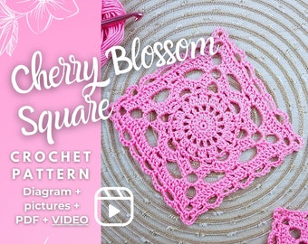 May include: A pink crocheted square with a floral design, labeled "Cherry Blossom Square." The image includes a ball of pink yarn, a crochet hook, and text indicating a crochet pattern with diagrams, pictures, PDF, and video instructions.