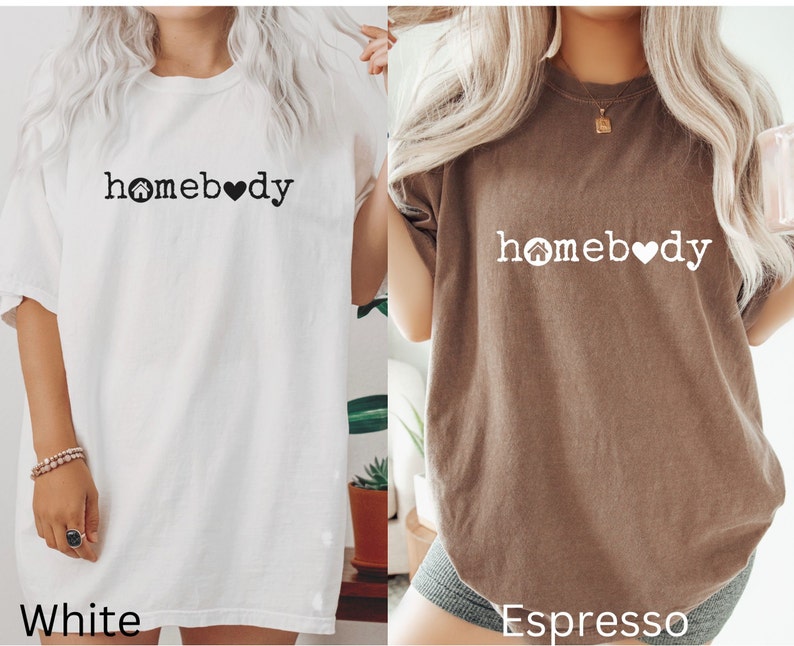 Pode incluir: Duas camisetas oversized com o texto "homebody" e um gr&aacute;fico de uma casa e um cora&ccedil;&atilde;o. A camiseta &agrave; esquerda &eacute; branca e a camiseta &agrave; direita &eacute; expresso.