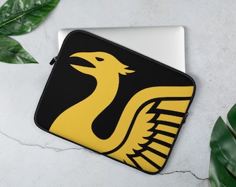 May include: Black laptop sleeve featuring a stylised yellow bird design. The bird has a long neck and a wing with a geometric pattern.