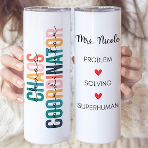May include: Two white stainless steel tumblers with colorful text. The first tumbler says "Chaos Coordinator". The second tumbler says "Mrs. Nicole Problem Solving Superhuman" with a red heart between each line of text.