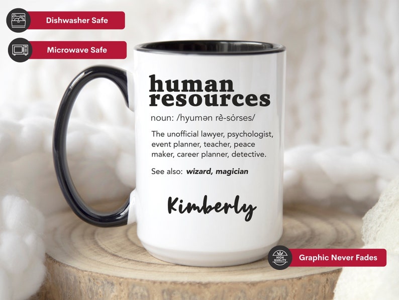 May include: White ceramic mug with a black rim and handle. The mug features a black graphic that says "human resources" with a definition and the name "Kimberly". The mug is dishwasher and microwave safe.