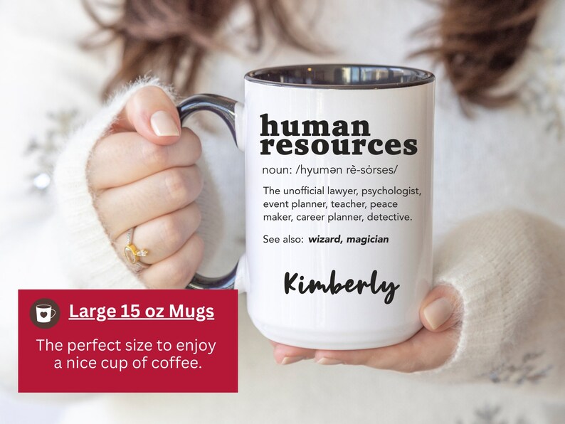 May include: White ceramic mug with a black rim and handle. The mug has black text that reads "human resources" with a definition and the name "Kimberly". The mug is 15 ounces and is part of a set of large mugs.