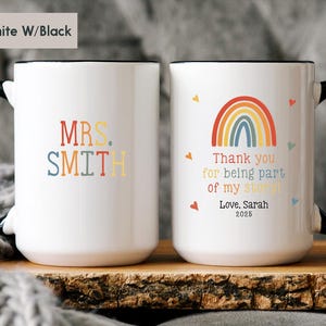 May include: White ceramic coffee mug with a black handle and rim. The mug has a rainbow design with the text "Thank you for being part of my story! Love, Sarah 2025". The other side of the mug has the text "MRS. SMITH" in colorful letters.