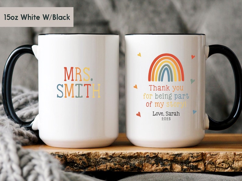 May include: White ceramic coffee mug with a black handle and rim. The mug has a rainbow design with the text "Thank you for being part of my story! Love, Sarah 2025". The other side of the mug has the text "MRS. SMITH" in colorful letters.