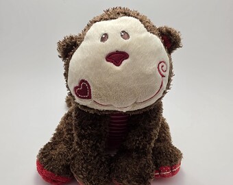 Peluche de mono marrón con corazón rojo de Mary Meyer Cheery Cheeks (25 cm)