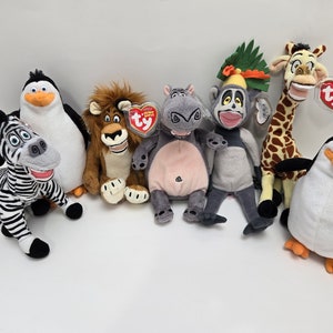 May include: A set of eight plush toys from the Madagascar movie franchise. The toys include Alex the lion, Marty the zebra, Melman the giraffe, Gloria the hippopotamus, Skipper the penguin, Kowalski the penguin, Rico the penguin, and Private the penguin.
