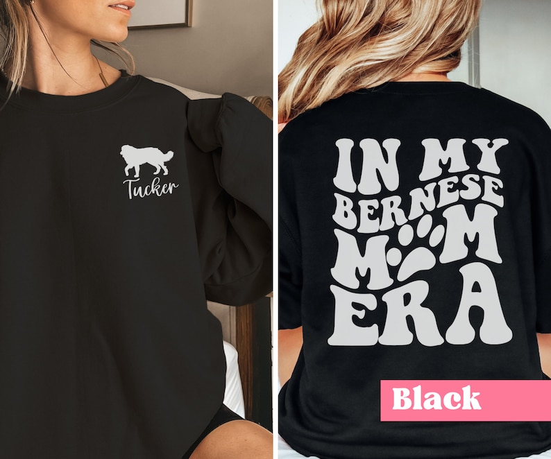 May include: Black sweatshirt with a white silhouette of a Bernese Mountain Dog and the text "Tucker" on the front. The back of the sweatshirt has the text "In My Bernese Mom Era" in a retro font with paw prints.