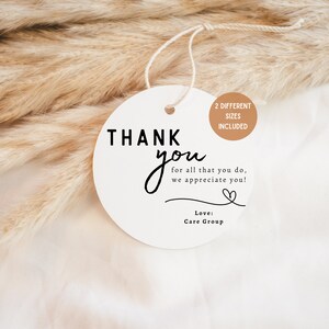 May include: White round thank you tag with black text that reads "THANK you for all that you do, we appreciate you!" with a small heart symbol and the text "Love: Care Group". The tag has a brown circle with the text "2 DIFFERENT SIZES INCLUDED".