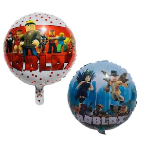 May include: Two Roblox themed foil balloons. One balloon is white with red polka dots and features a group of Roblox characters with the word "Roblox" printed in red. The other balloon is blue with a cityscape background and features a Roblox character with wings and the word "Roblox" printed in red.