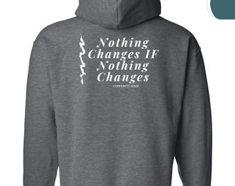 May include: A charcoal grey hooded sweatshirt with long sleeves. The back displays the white text "Nothing Changes IF Nothing Changes" and "Community Good". A white graphic is on the left side of the text.