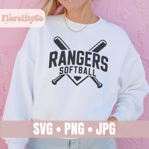 May include: White sweatshirt with a black "Rangers Softball" graphic featuring crossed baseball bats. The design includes the text "SVG &bull; PNG &bull; JPG" at the bottom. The sweatshirt is a casual style.
