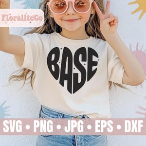 May include: A white t-shirt with a black heart-shaped design that says "BASE" inside. The heart has small white stars around it.