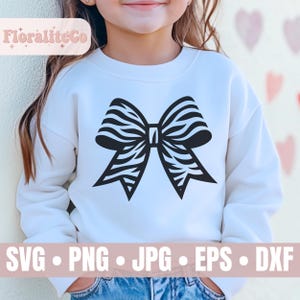 Op de afbeelding: Een wit sweatshirt met een zwart-witte zebraprint strik op de voorkant. De tekst "SVG - PNG - JPG - EPS - DXF" staat onderaan de afbeelding.