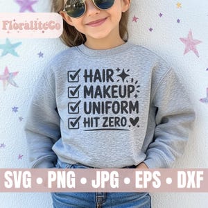 May include: A light gray sweatshirt with the words "HAIR, MAKEUP, UNIFORM, HIT ZERO" in black text. The sweatshirt is worn by a child wearing sunglasses. The bottom of the image shows the words "SVG, PNG, JPG, EPS, DXF".