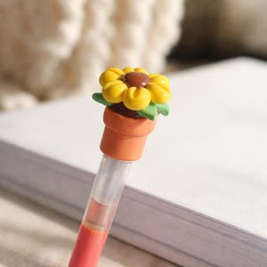 Penntopping med vikt i solroslera | Bläckflödeshjälpmedel