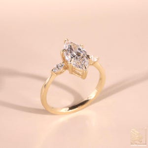 Lab Created Diamond
Marquise Diamond
Vintage Marquise 10k
Wedding Ring 18kt
3.50 CT Marquise Cut Three Stone Engagement Ring, 14K/18K Solid Yellow Gold, Side Stone Pear Cut Diamonds, Promise Wedding Ring Gift For Her
Marquise Cut Moissanite Ring with Pear Side Stones | Three Stone Moissanite Engagement Ring in Yellow Gold | Elegant Marquise Ring for Her
marquise three stone ring
Silver wedding ring
white gold wedding ring
silver engagement ring women,
trilogy ring women, mens engagement ring,
