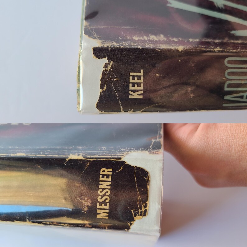 May include: Close-up of the side of two books with the titles "Keel" and "Messner" visible. The book edges are worn and show signs of age, with a distressed, vintage aesthetic. The books have a dark color scheme.