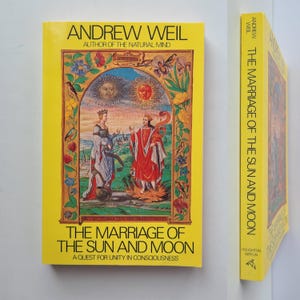 May include: A yellow book titled "The Marriage of the Sun and Moon" by Andrew Weil. The cover features an illustration of two figures, suns, and floral elements. The book's spine is also visible, displaying the title and author.