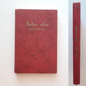 May include: A red hardcover book titled "Indian Lore" by Lamb and Shultz. The book has a textured cover.