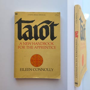 May include: A vintage book titled "Tarot: A New Handbook for the Apprentice" by Eileen Connolly. The cover is a light tan color with black lettering and a circular emblem. The book's spine is also visible.