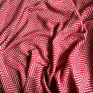 May include: Red and white chevron patterned throw blanket with a soft, fuzzy texture.