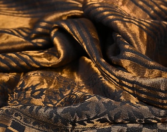 May include: A brown and black patterned fabric with a checkered design. The fabric has a shiny, satin-like finish.