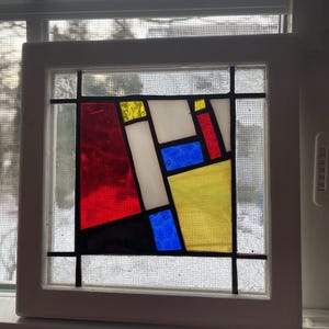 Wood framed, stained glass window panel.