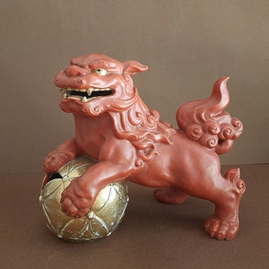 Porcelain sculpture of a talisman of the mystical creature Komainu with a magic ball Kutani Workshops Japan, 1900s Fu Dog