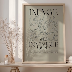 May include: A framed print with a green background and black text that reads "IMAGE of the INVISIBLE GOD HE IS THE IMAGE OF THE INVISIBLE GOD THE FIRSTBORN OVER ALL CREATION COLOSSIANS 1:15". The print features a black and white illustration of branches with leaves.