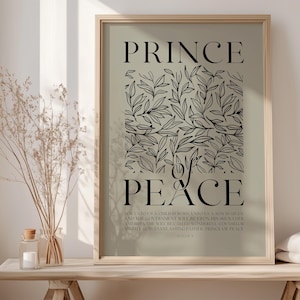 May include: A printable wall art design with a green background and black text that reads "Prince of Peace". The text is surrounded by a black floral design. The text below the floral design reads "For unto us a child is born, unto us a son is given: and the government will be upon his shoulder: and his name shall be called Wonderful, Counsellor, The mighty God, The everlasting Father, The Prince of Peace." - Isaiah 9:6