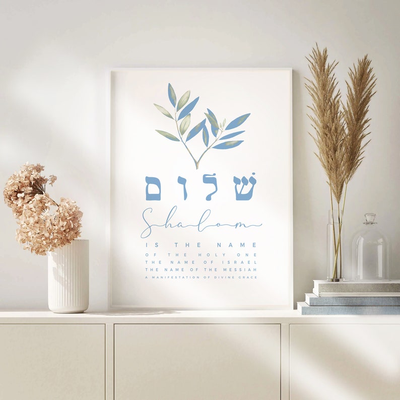 May include: A printable wall art design featuring a blue watercolour olive branch with the Hebrew word "Shalom" written in blue letters. The text below reads "Shalom is the name of the Holy One, the name of Israel, the name of the Messiah, a manifestation of divine grace."