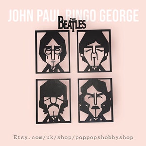 May include: Black cut-out portraits of The Beatles band members: John, Paul, Ringo, and George. The band's name is displayed above the portraits. The Etsy shop URL is at the bottom. The portraits are on a light pink background.
